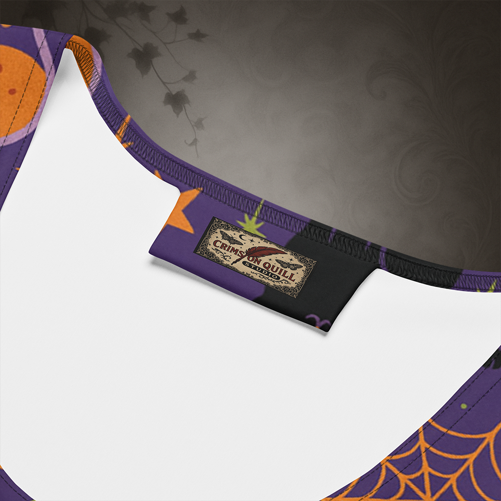 Close-up of a Halloween-themed crop top with a brand label on a dark background