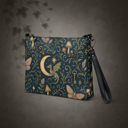 Handbag with fantasy design featuring dragons, moons, and plants on a dark background